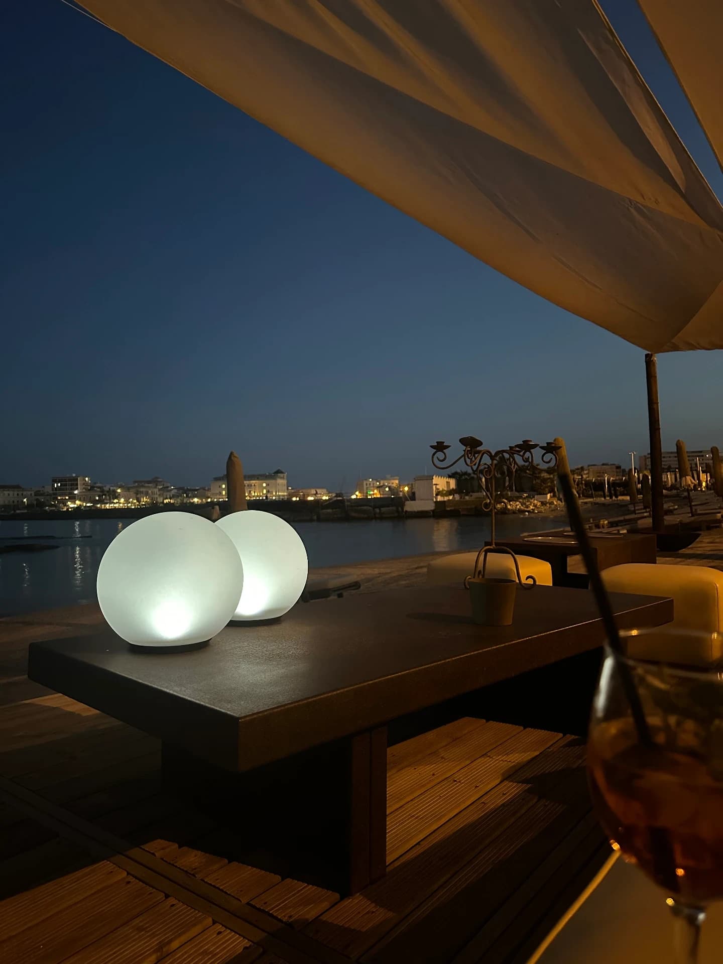Evening lounge with lamps by the sea