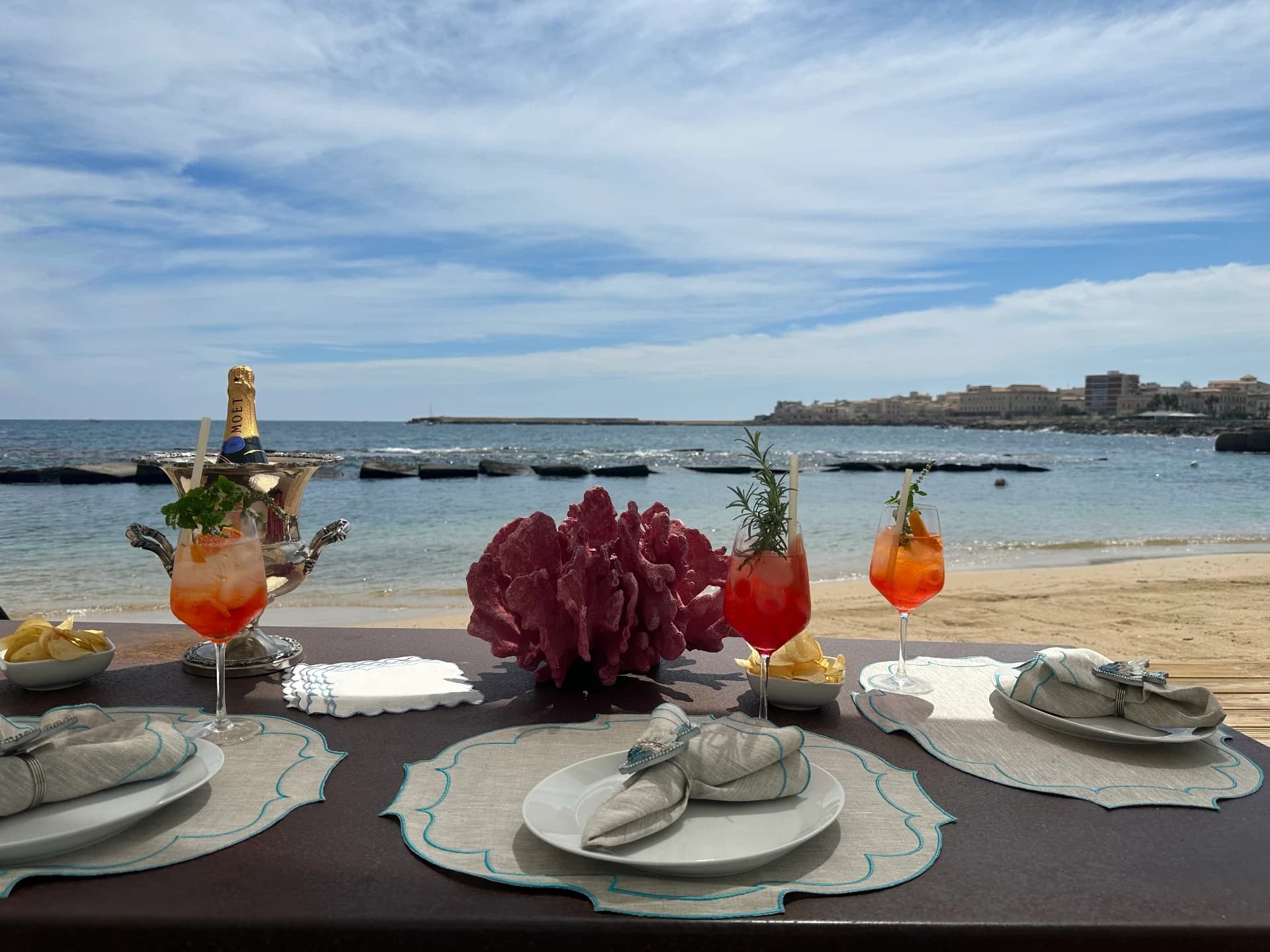 Beach table with aperitifs at sunset
