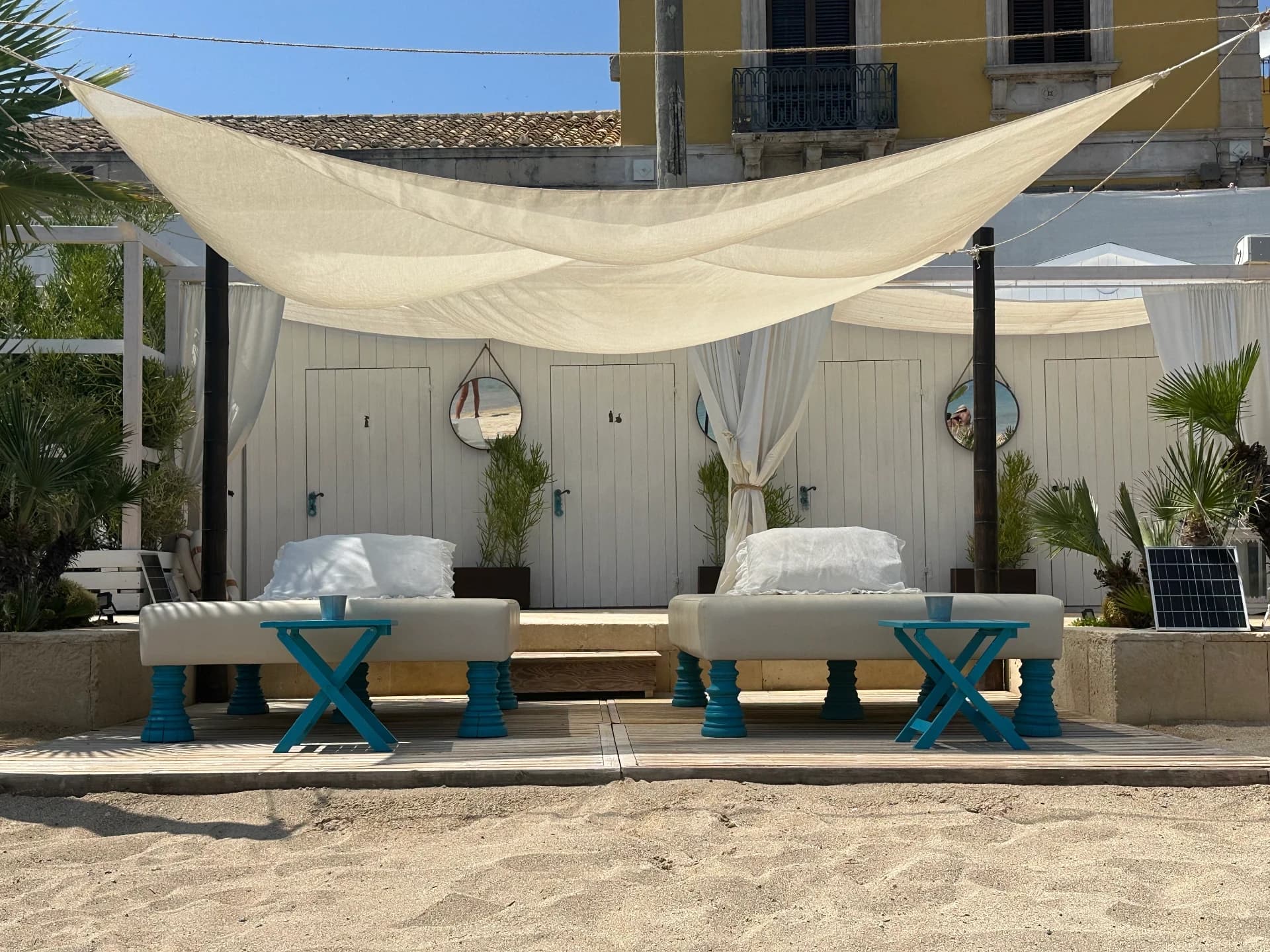 Beach club with sunbeds and canvas cabanas