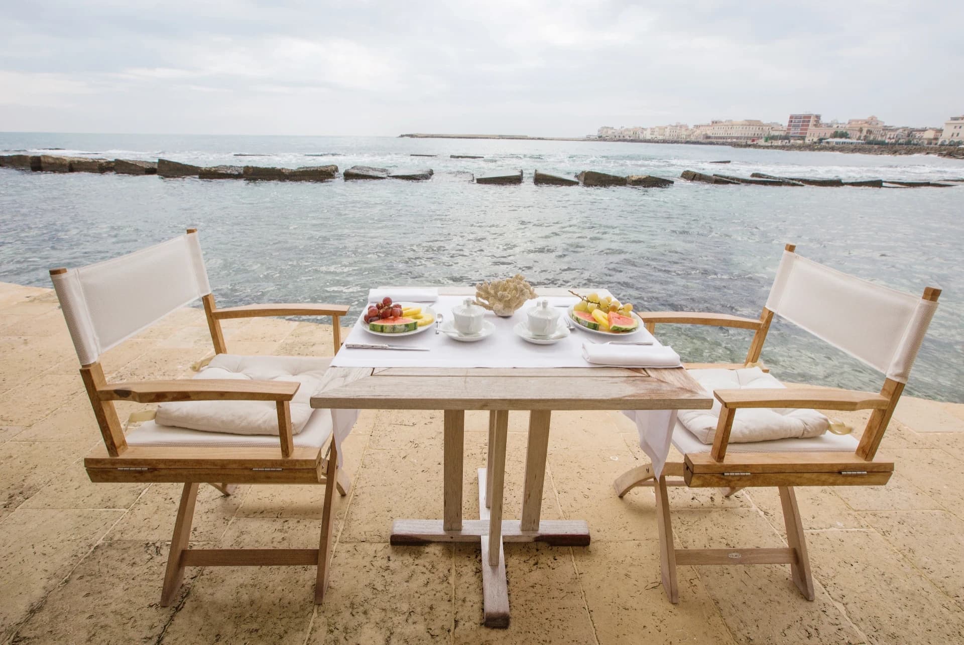 Seaside breakfast with fruit and coffee