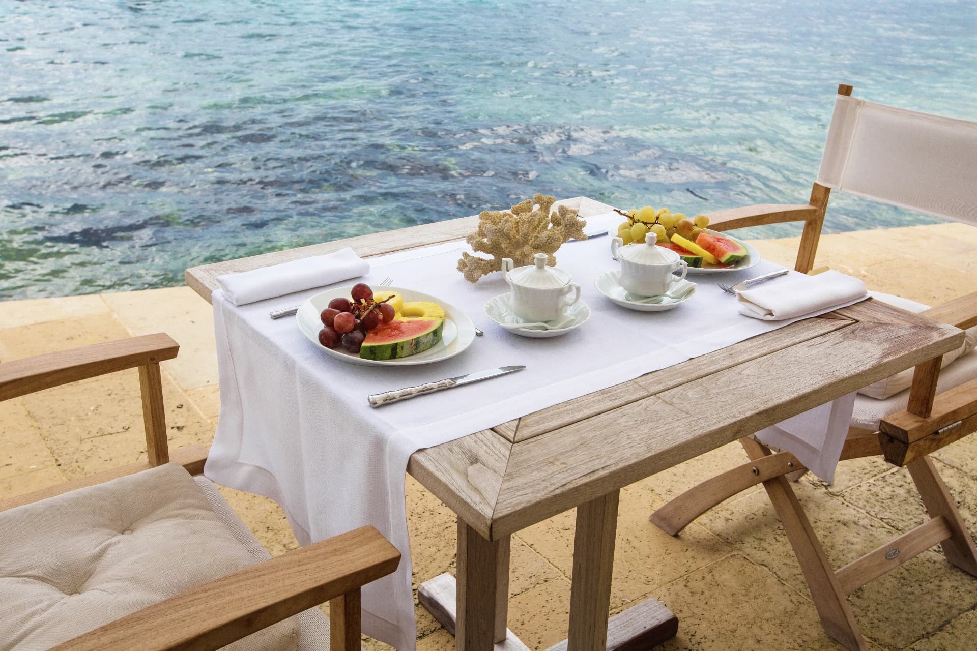 Table with fruit and coffee by the sea