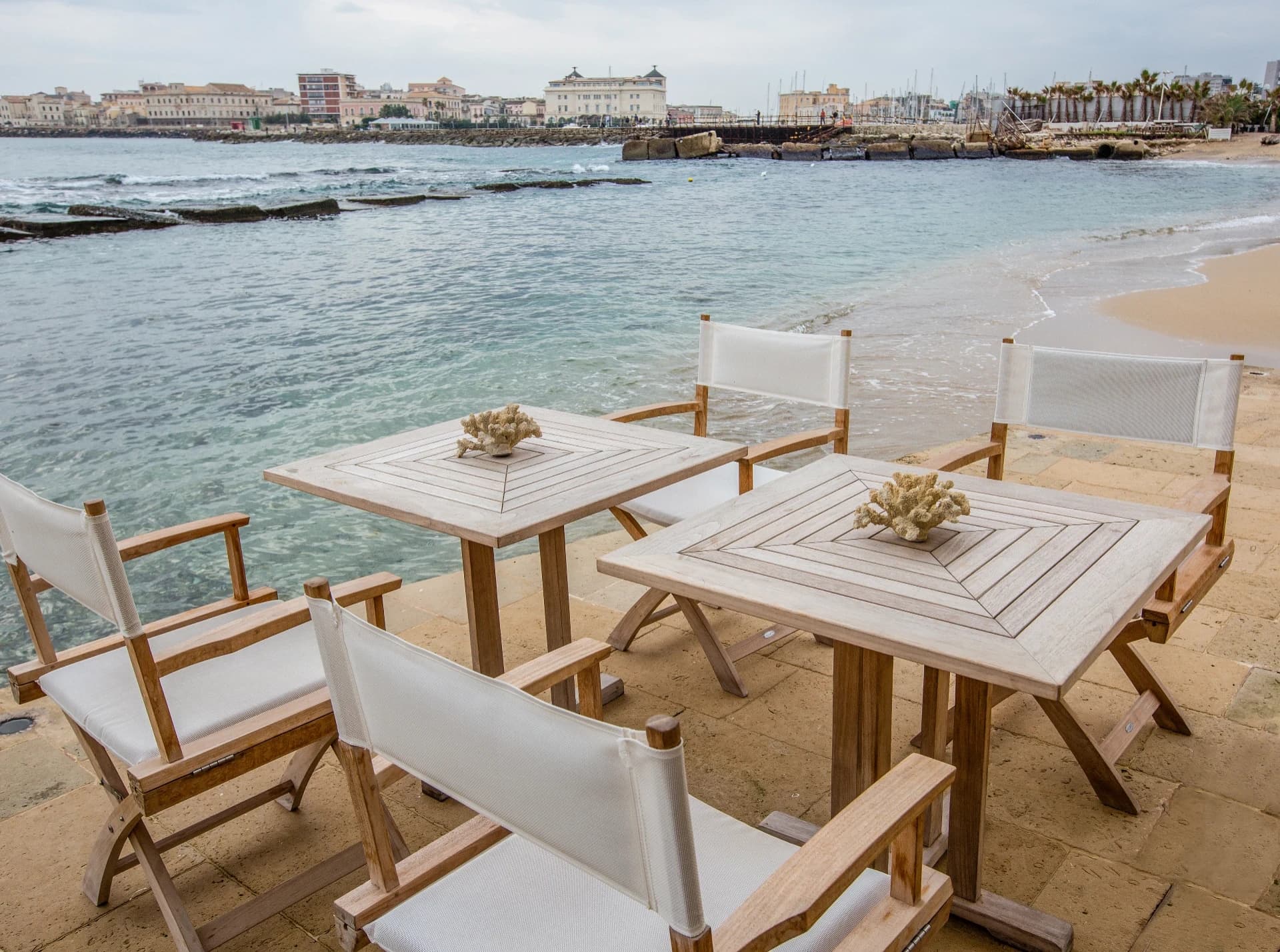 Tables and chairs facing the sea