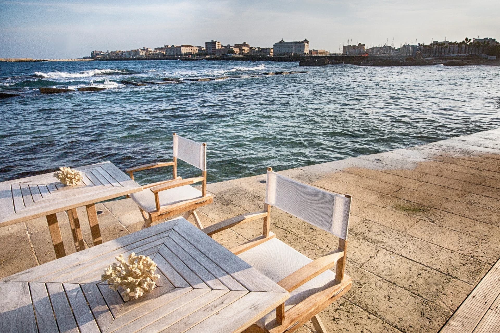 Wooden loungers on the seafront terrace