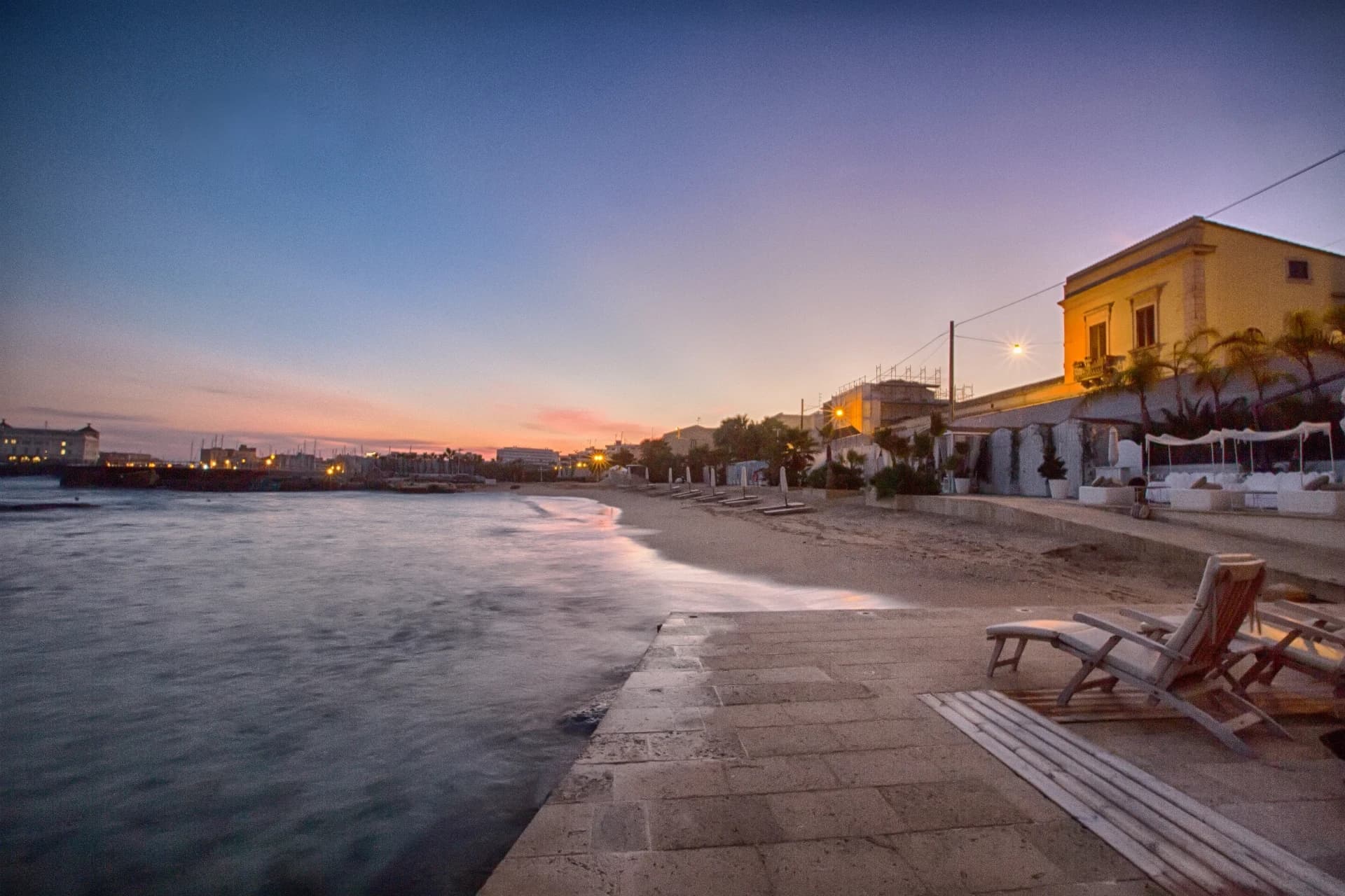 Sunbeds on the seafront at sunset