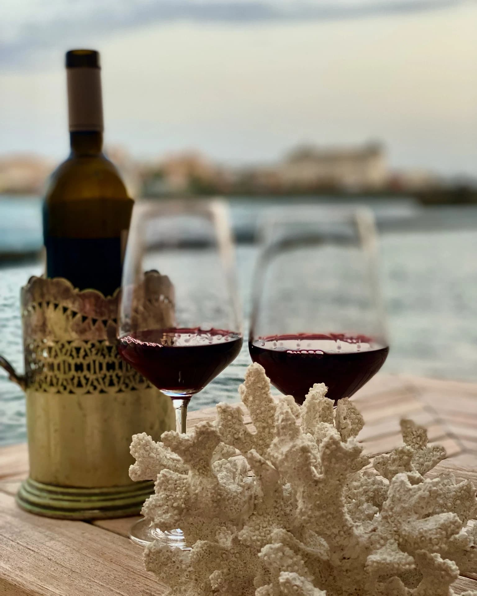 Wine and coral on the seafront terrace