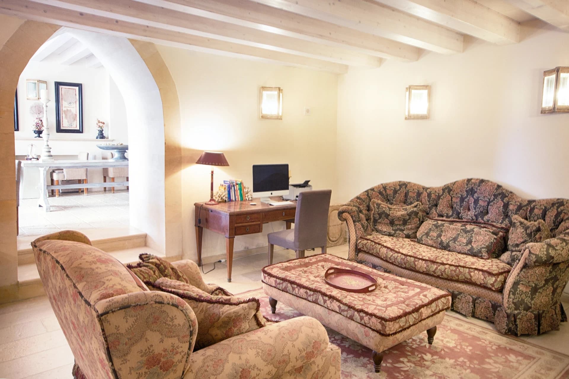 Lounge with floral sofas and arches