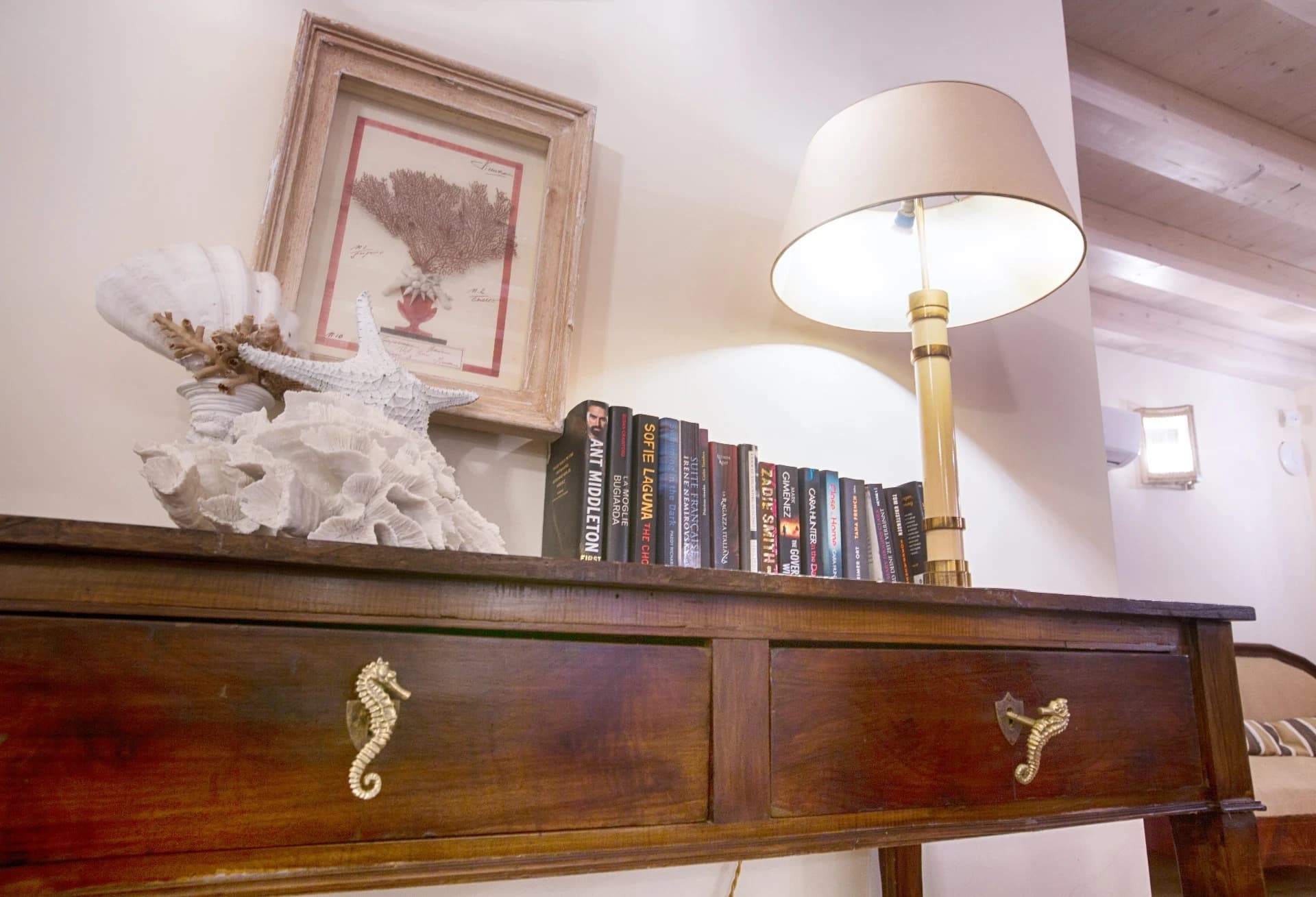 Console detail with books and lamp