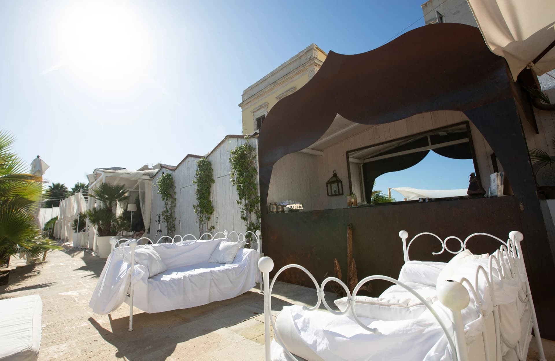 Wrought-iron beds on the seafront terrace