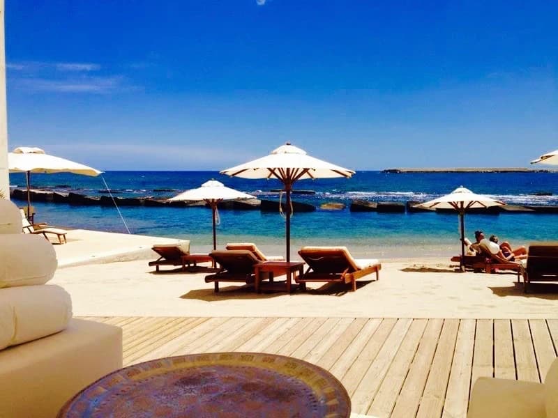 Beach club with deck and umbrellas by the sea