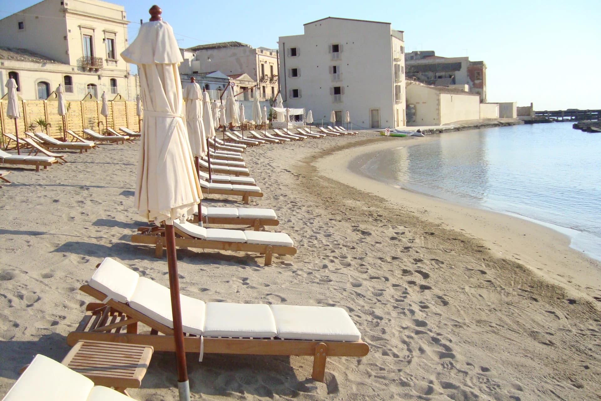 Beach with white umbrellas and golden sand
