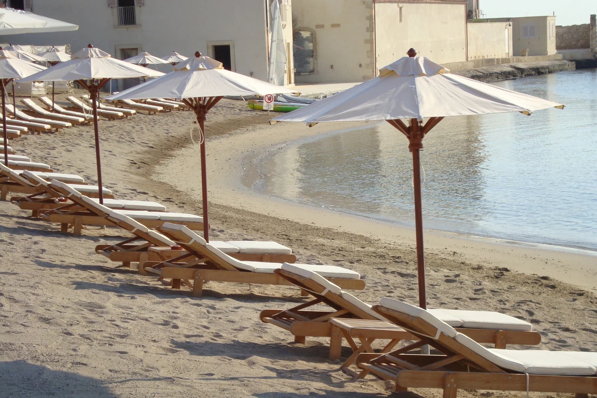 Cove with umbrellas and turquoise sea at Musciara Resort