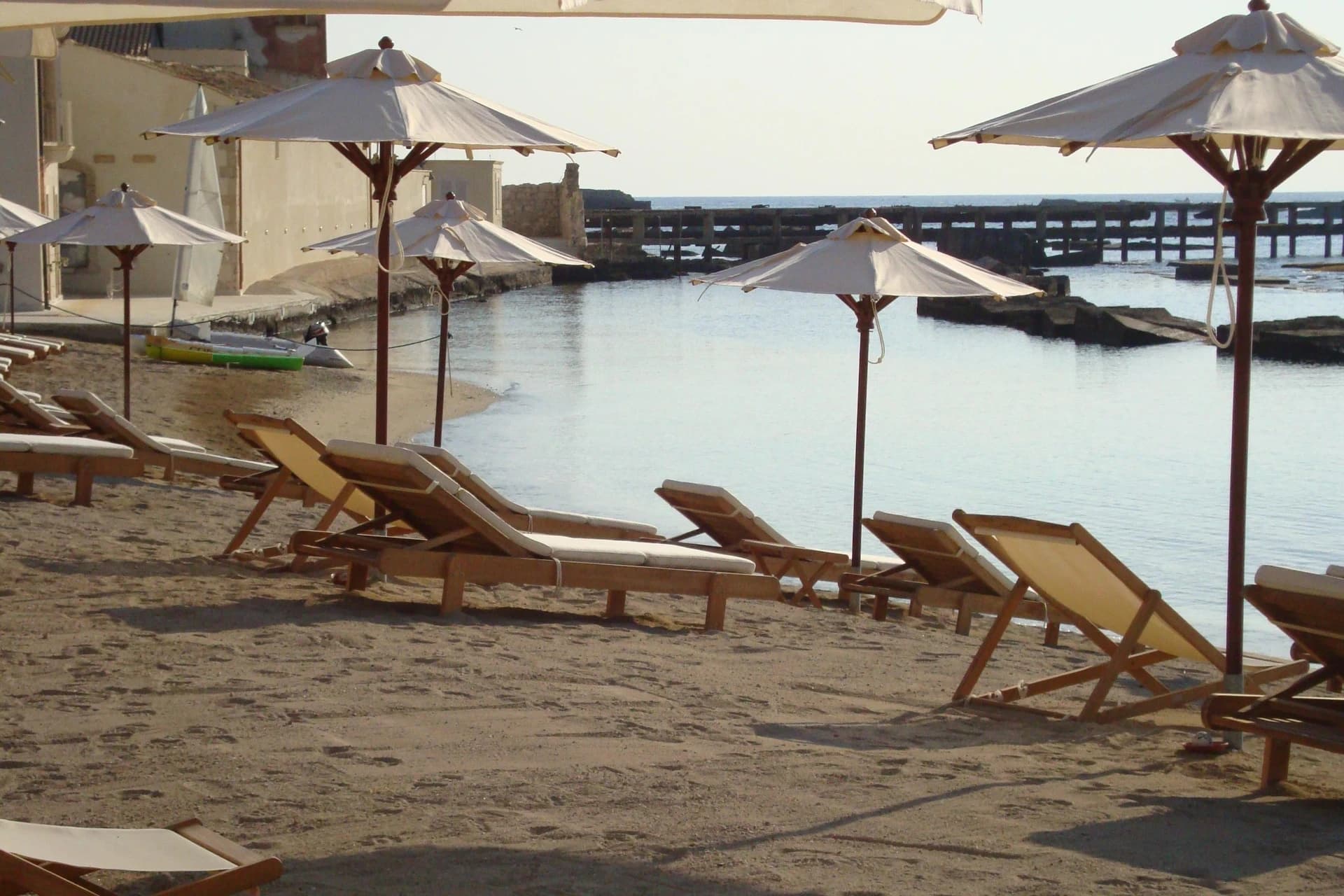 Musciara Resort beach with umbrellas and turquoise sea