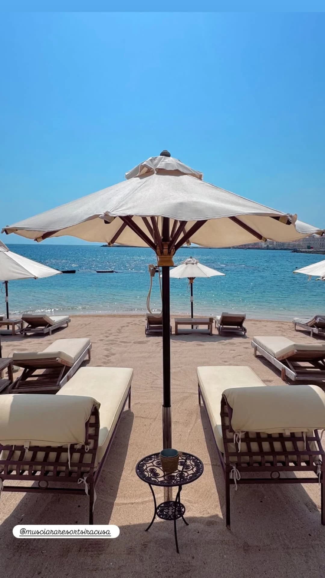 Umbrellas and sunbeds by the turquoise sea
